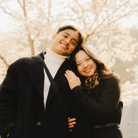 Priam and Eden cheek to cheek under the blossoms