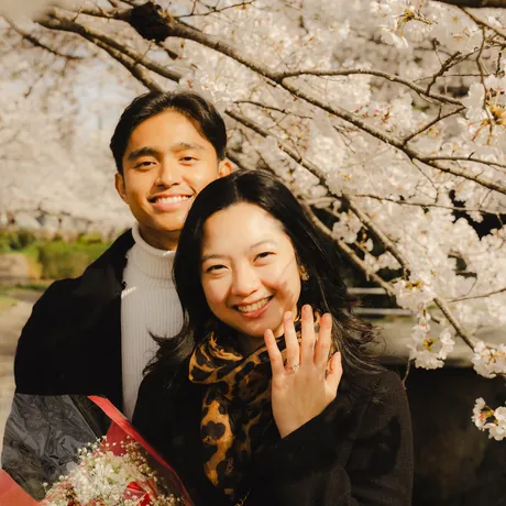 Eden laughing with Priam under the cherry blossoms