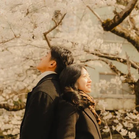 Priam and Eden looking up together at the cherry blossoms