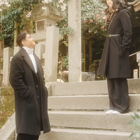 Priam and Eden standing together on temple steps